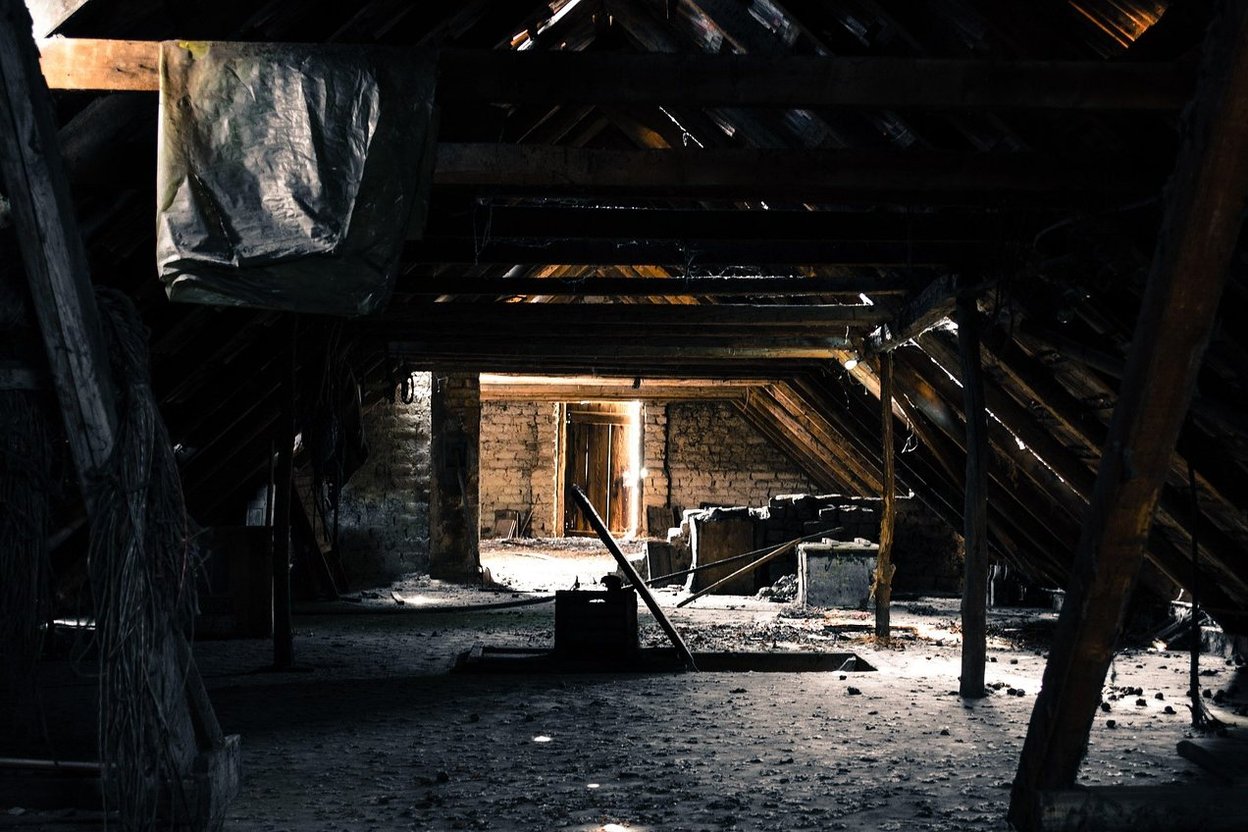 Inside an old attic under the roof tiles, with daylight coming through