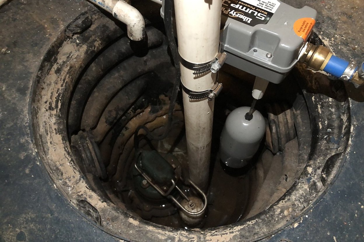 A sump pump installed in a basement sump pit