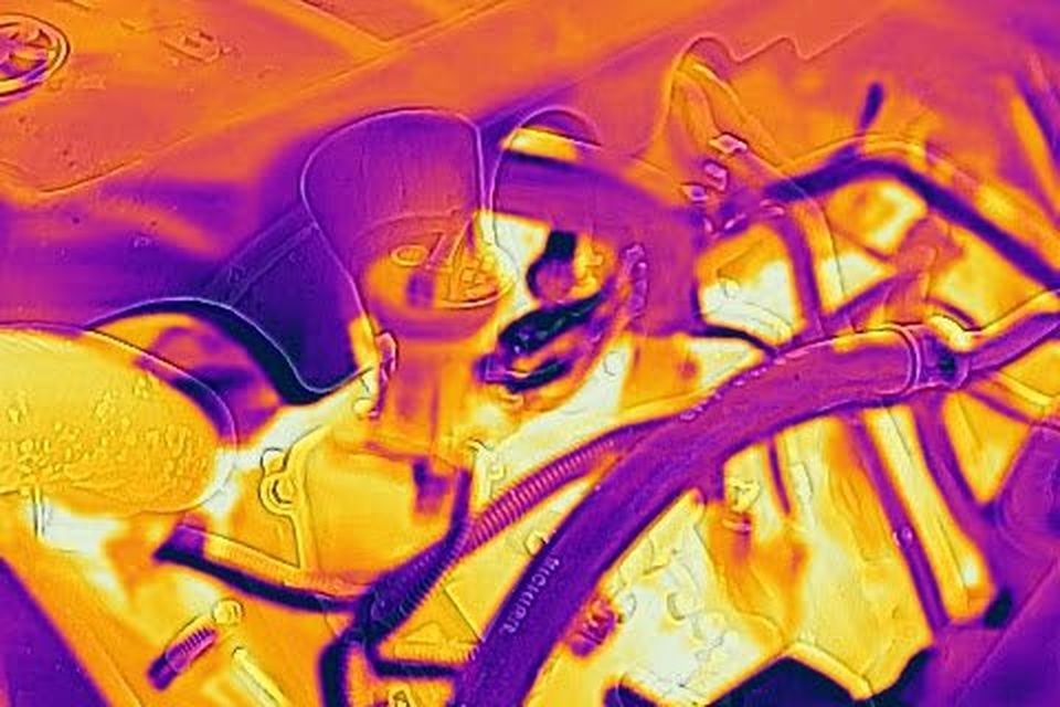 FLIR thermal image of a car engine showing hot and cool parts.